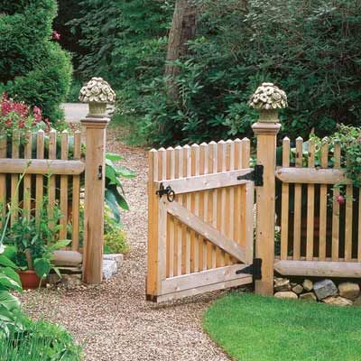 a wooden gate in the middle of a garden