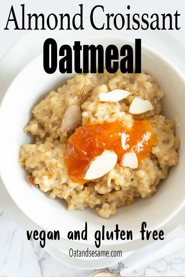 a bowl filled with oatmeal topped with almonds and an orange sauce