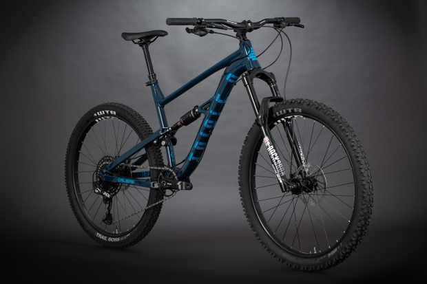 a blue and black mountain bike against a dark background