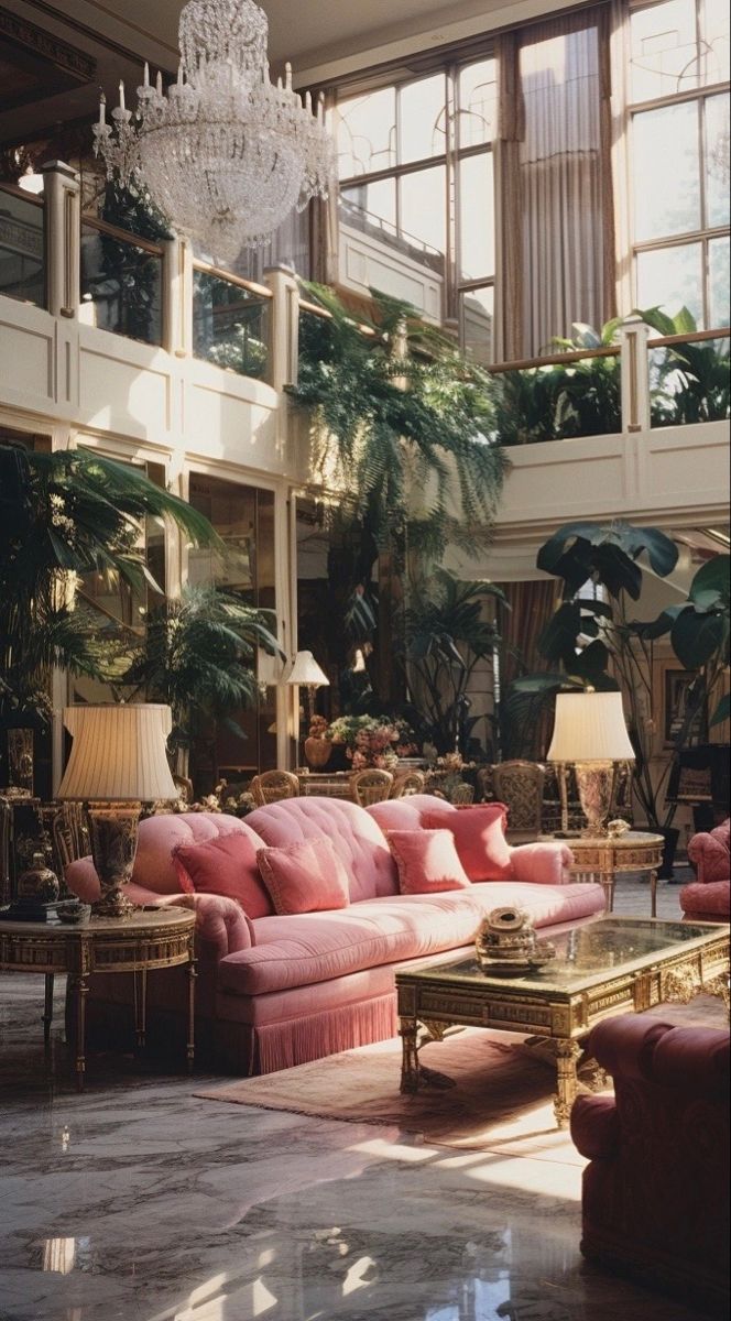 a living room filled with furniture and lots of windows next to a chandelier