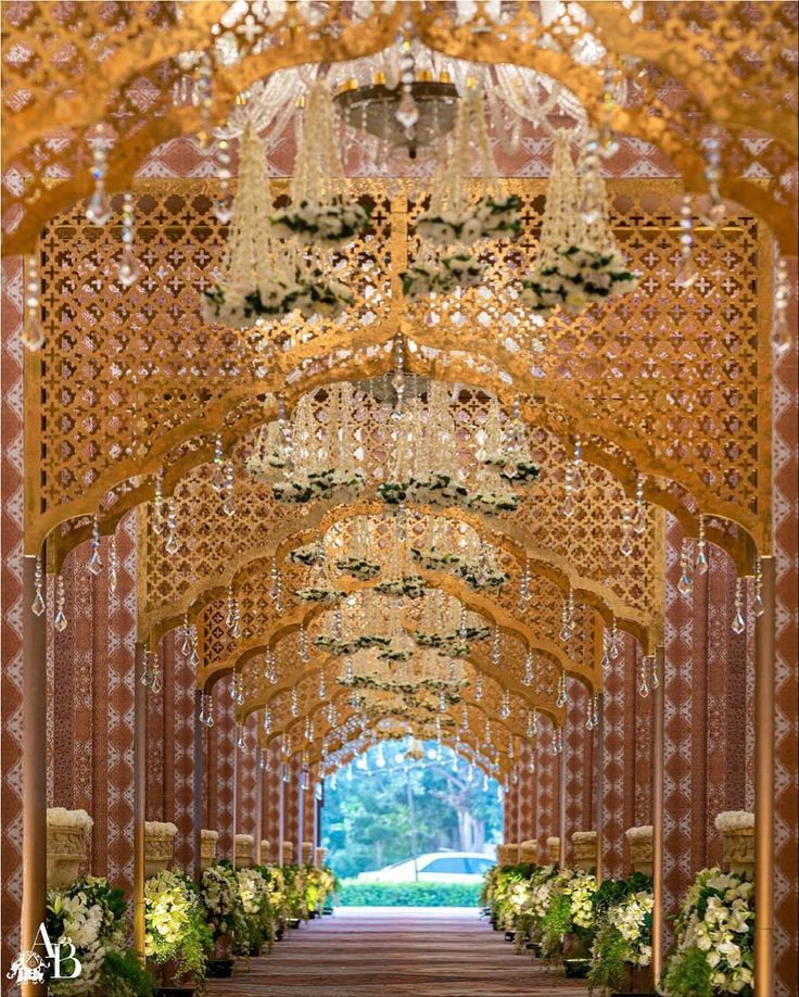 an ornate archway with chandeliers and flowers