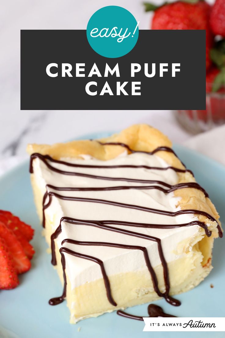 a piece of cream puff cake on a blue plate with strawberries in the background