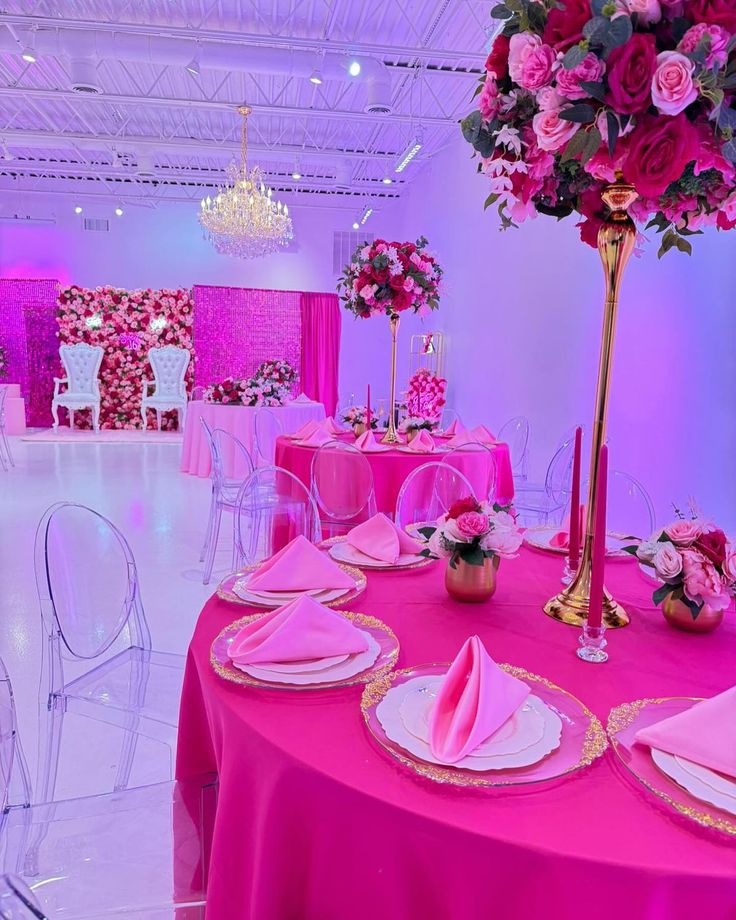 a table set up with pink linens and place settings