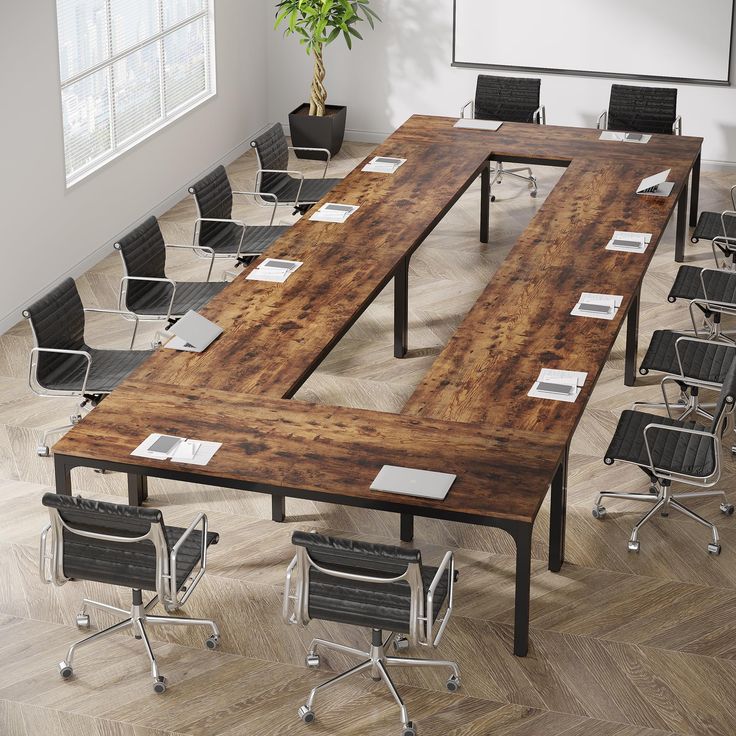 an empty conference table with chairs around it