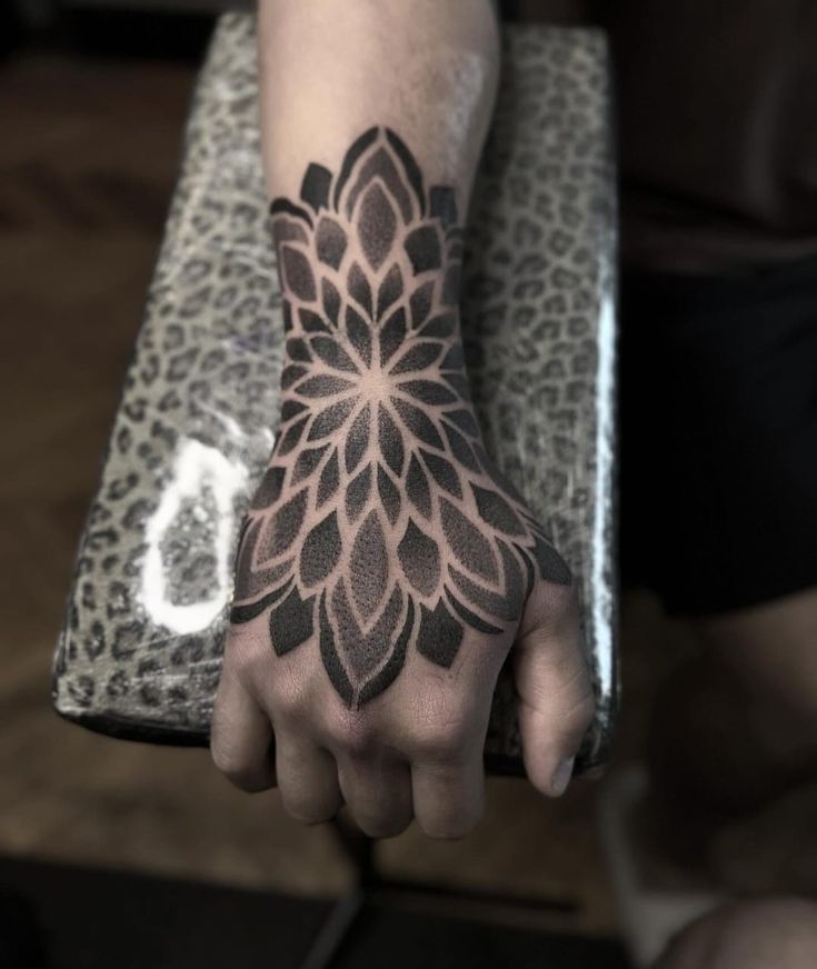 a person's hand with a tattoo on it