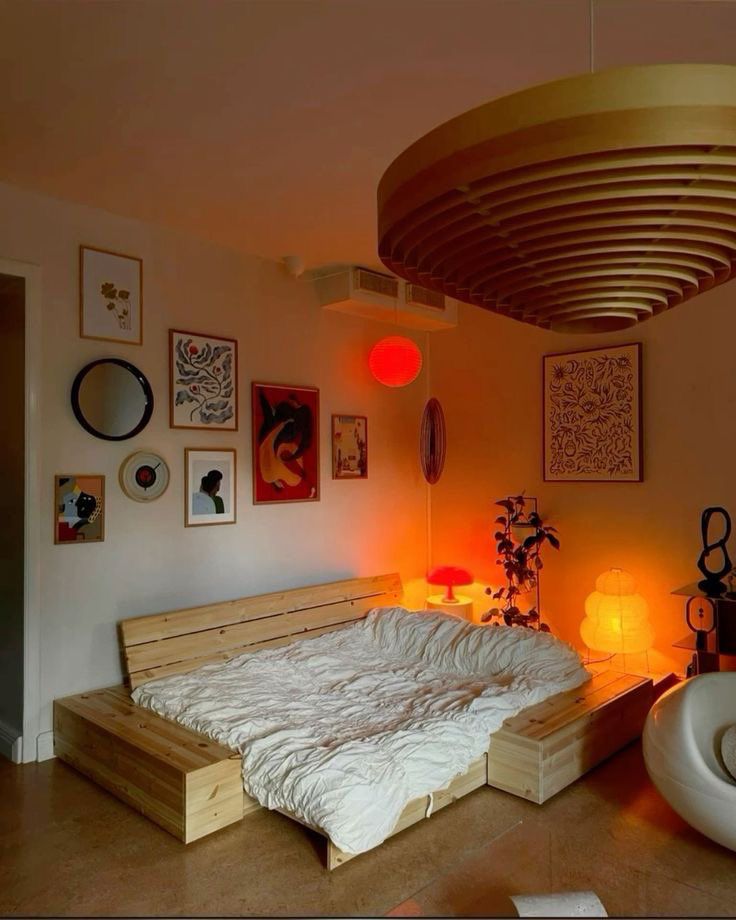 a bed sitting under a circular light in a bedroom