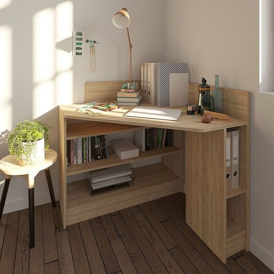 a desk with a book shelf next to it and a lamp on the side table