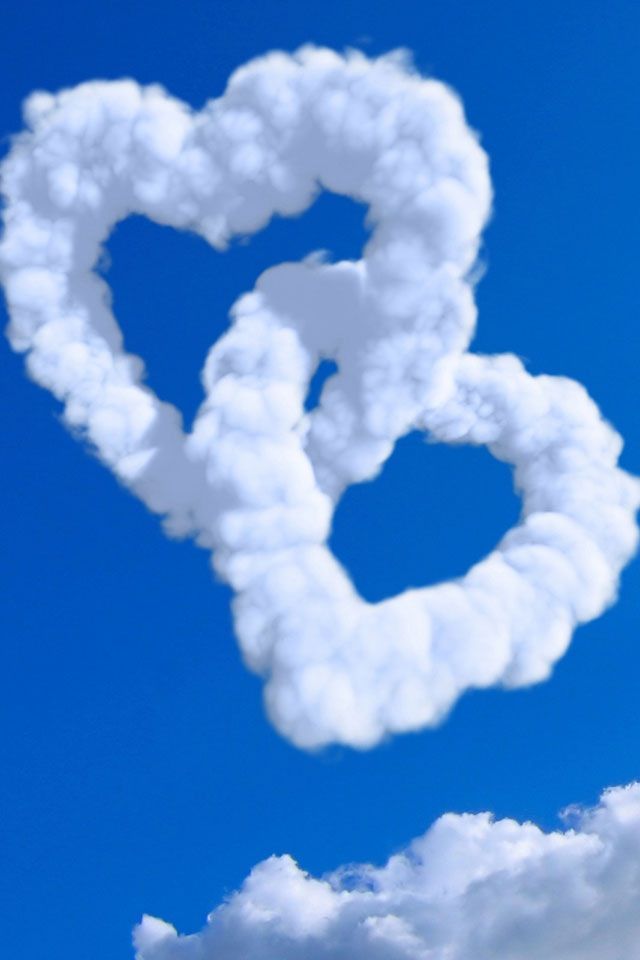 a heart shaped cloud floating in the sky