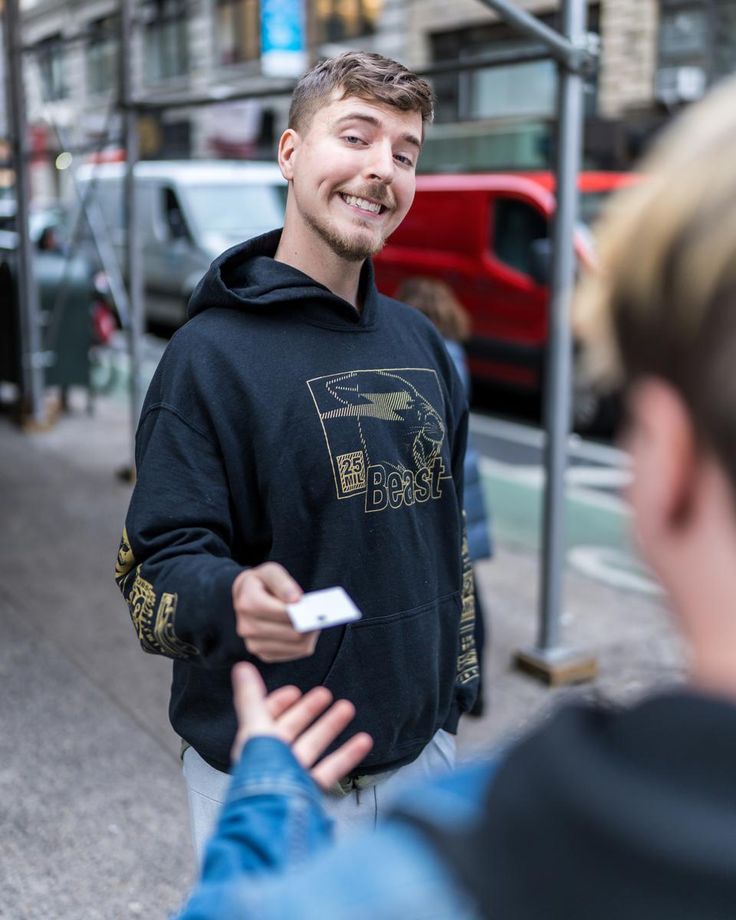 a man in a black hoodie is talking to someone