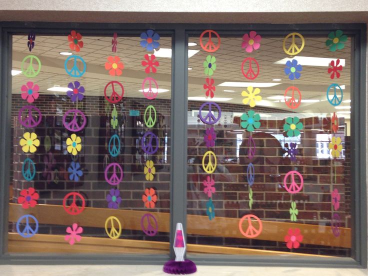 a window decorated with peace signs and flowers