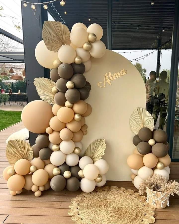 an arch made out of balloons and seashells for a wedding or baby shower