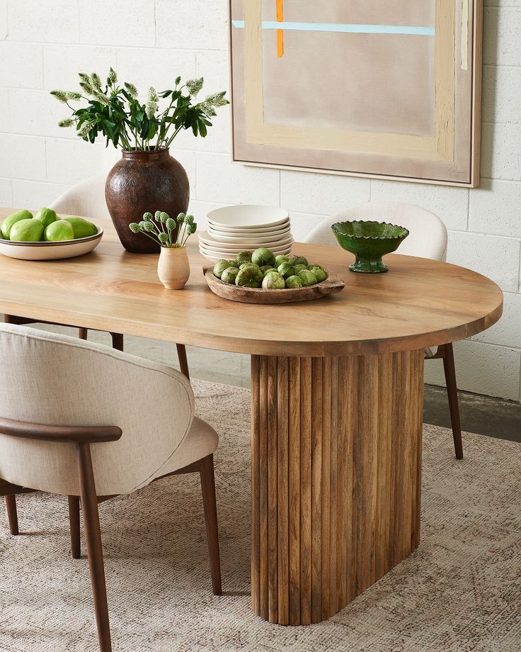 a wooden table with plates and bowls on it in the middle of a living room