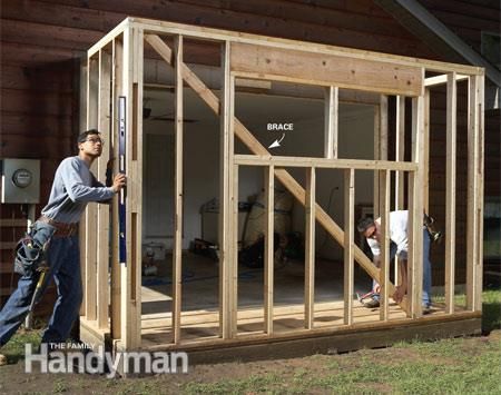 two men are working on the framing of a house