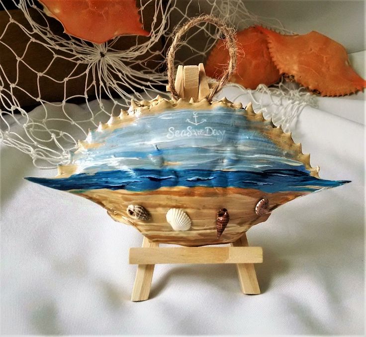 a wooden boat with seashells on it