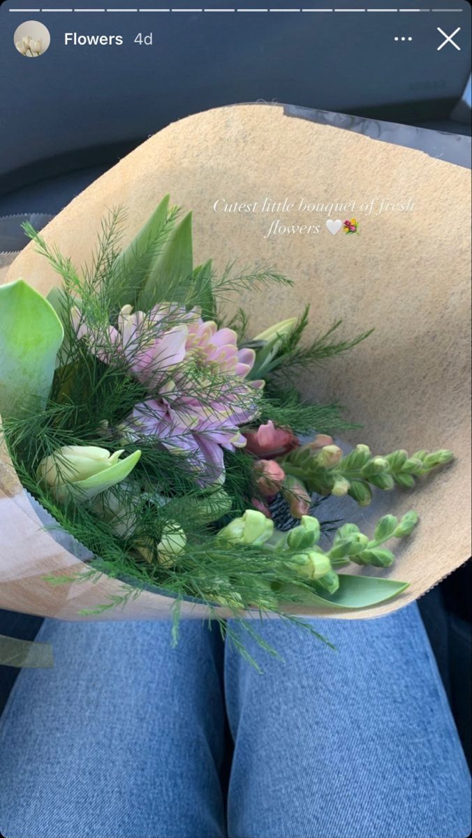 a person holding a bouquet of flowers in their lap