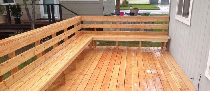 a wooden bench sitting on top of a wooden deck