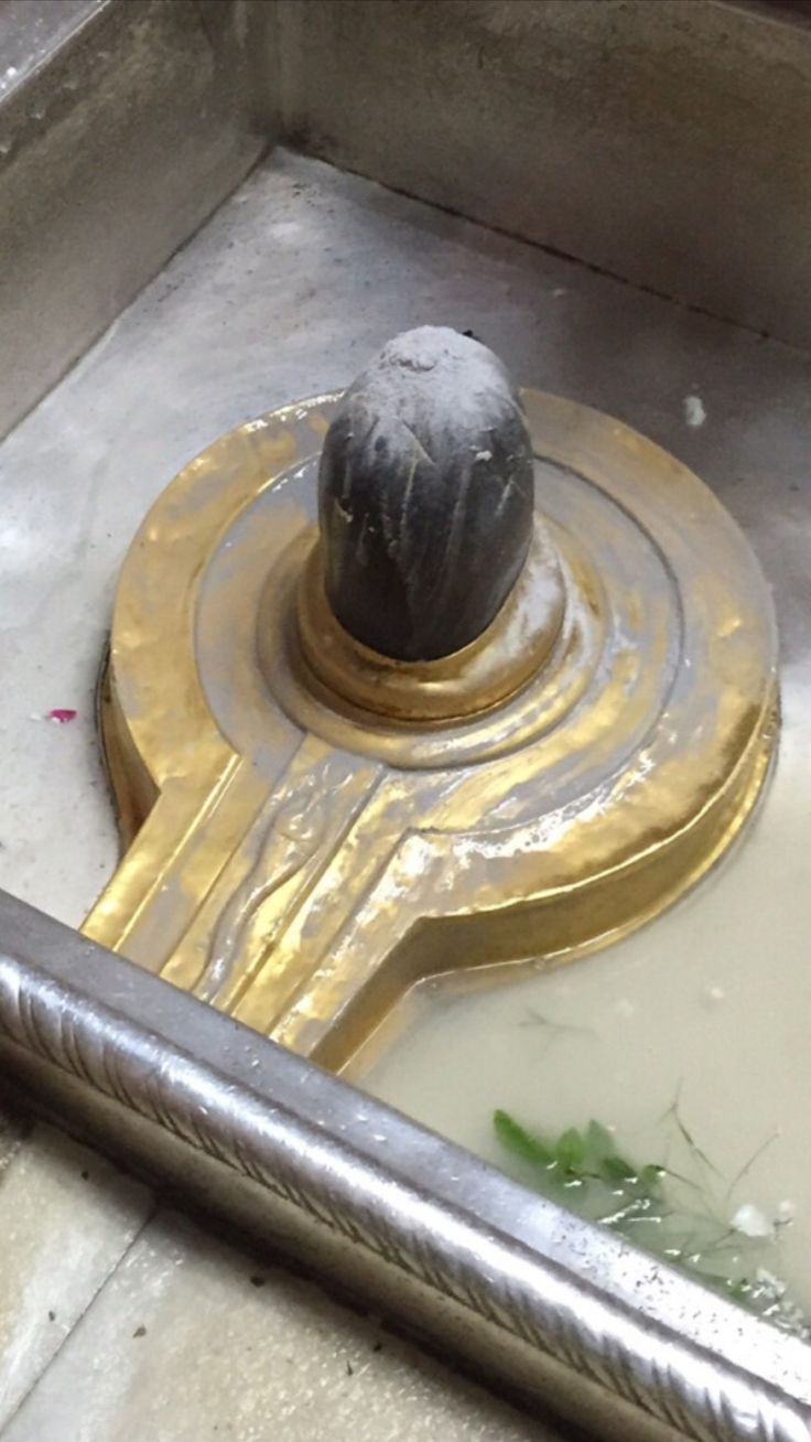 a metal object sitting on top of a cement floor