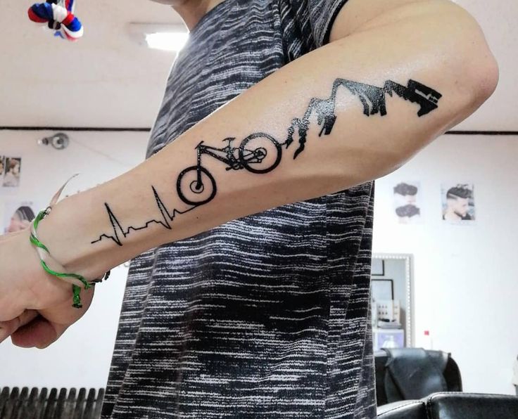 a man with a bike tattoo on his arm