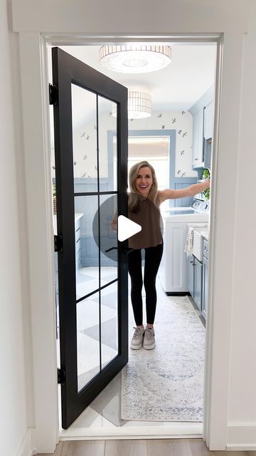 a woman standing in front of an open door