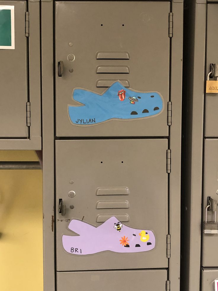 two lockers with stickers on them in a room filled with lockers and cabinets