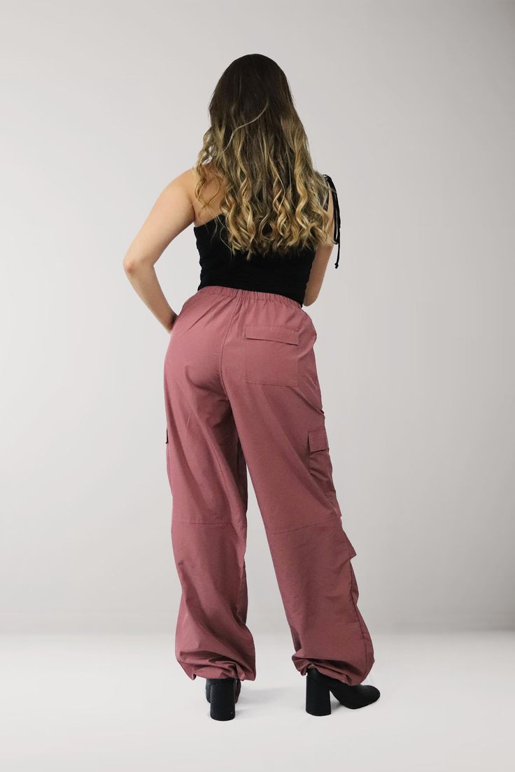 Elevate your street style with our Cargo Trousers, featuring a trendy pink tone and a comfortable, lightweight design perfect for the spring and summer seasons *FINAL SALE ITEM* Material & Care: Made from 100% polyester, our garments offer a lightweight and breathable feel. For best results, machine wash cold on gentle cycle and tumble dry low. Cool iron if needed. Do not bleach or dry clean. Size & Fit: Our model is wearing a size XS Casual Pink Pants With Cargo Pockets, Pink Cotton Cargo Pants For Streetwear, Casual Pink Nylon Pants, Trendy Pink Parachute Pants For Spring, Spring Nylon Pink Pants, Spring Pink Nylon Bottoms, Pink Summer Streetwear Pants, Casual Stretch Cargo Pants For Summer, Casual Pink Cotton Cargo Pants