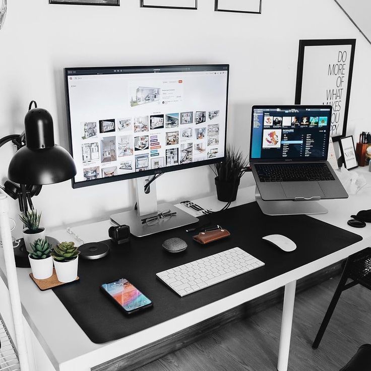 a desk with two monitors and a laptop on it