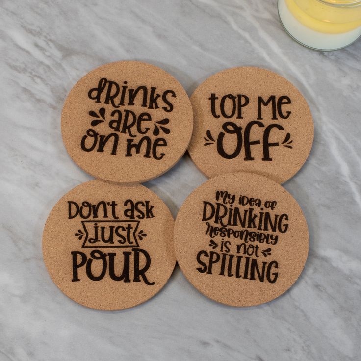 four cork coasters that say drinks are on me