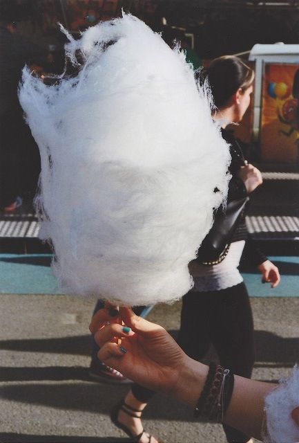 a person holding cotton candy in their hand with the words strive for childlike conference on it