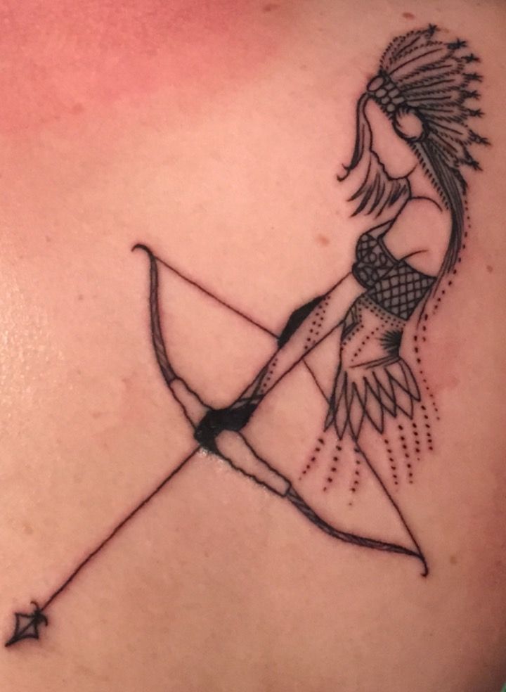 a woman with a bow and arrow tattoo on her back