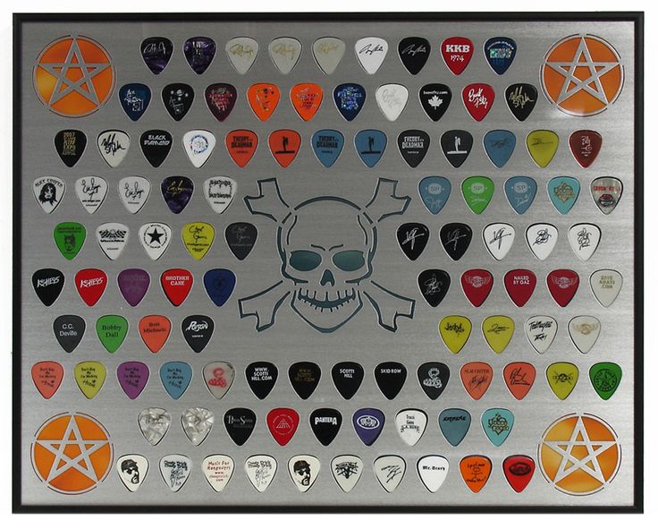 a metal plaque with many different colored guitar picks on it's sides and a skull in the middle