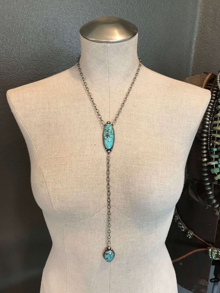 Women's Blue Stone Drop Body Necklace The Ace Lariat Necklace, 4 from Calli Co Silver Details Sterling silver turquoise Rope trim and sterling drop accents Adjustable link chain 18 1/2" long plus 9" lariat drop Stamped sterling and signed by Navajo artist Shop more from Calli Co Silver's Necklace Collection here! Silver Bohemian Lariat Necklace With Long Drop, Bohemian Silver Lariat Necklace With Long Drop, Bohemian Silver Long Drop Lariat Necklace, Nickel Free Sterling Silver Lariat Necklace, Turquoise Dangle Necklace, Turquoise Lariat Jewelry With Adjustable Chain, Sterling Silver Lariat Turquoise Necklace Gift, Sterling Silver Turquoise Necklace With Adjustable Chain, Southwestern Silver Lariat Necklace