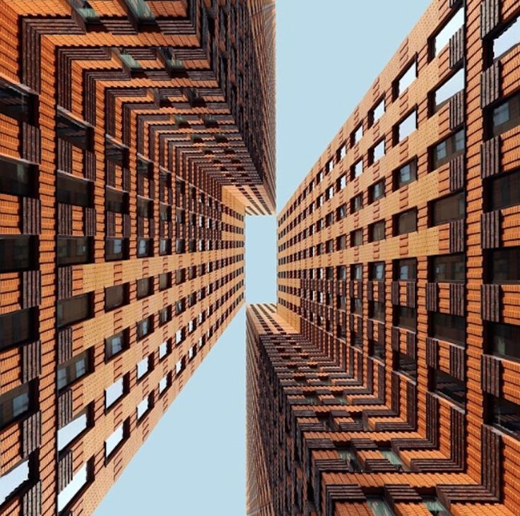 an upward view of some tall buildings