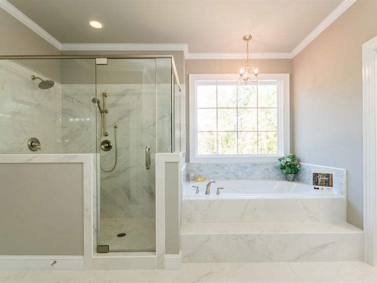 a large bathroom with a walk in shower next to a bathtub