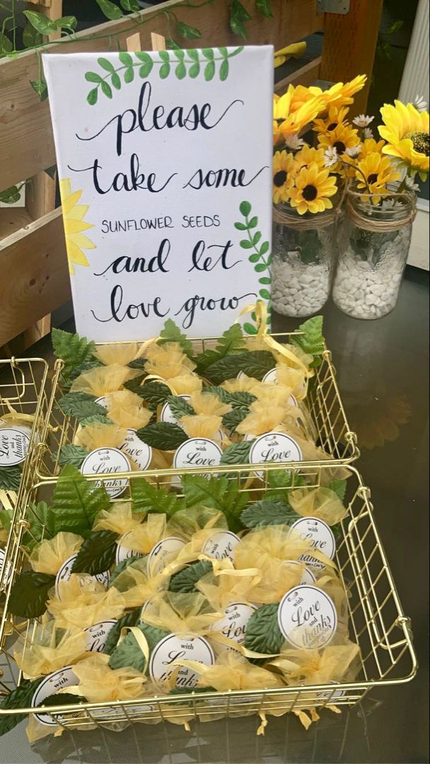 there are many small trays of food on the table with flowers in vases