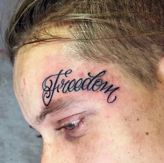 a man with a tattoo on his forehead has the word stradden written in cursive font