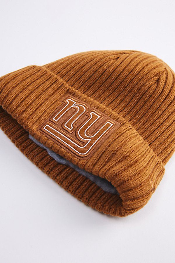 a beanie hat with the ugg logo on it, sitting on a white surface