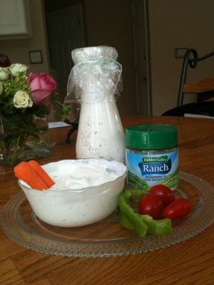 some vegetables and ranch dressing on a glass plate