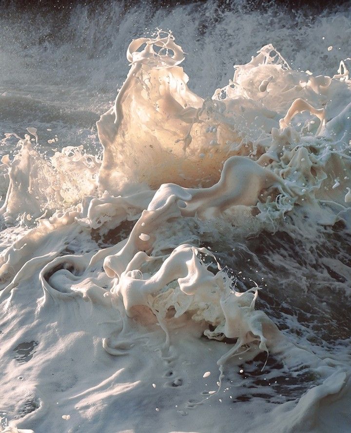 the water is splashing on top of the foamy waves in the ocean,