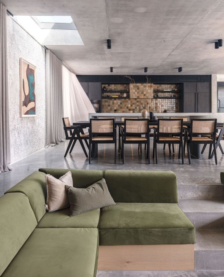 a living room filled with furniture next to a kitchen