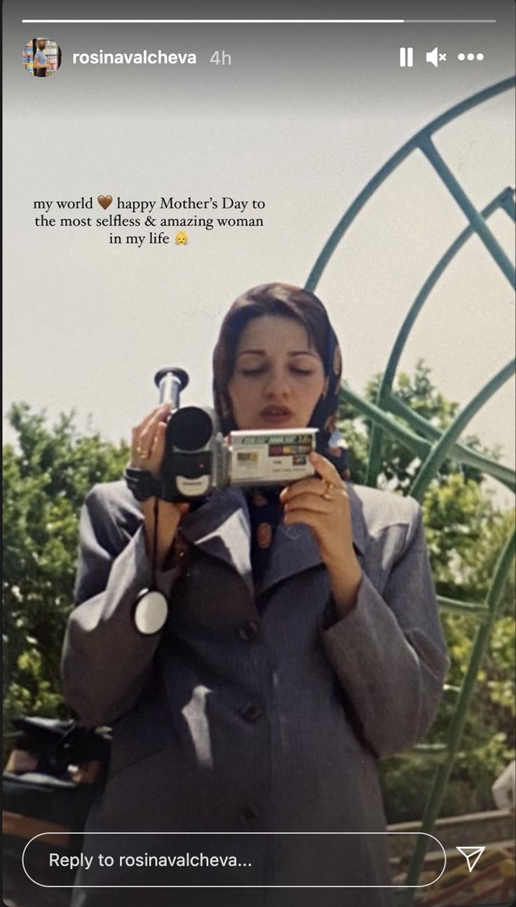 a woman holding a camera up to her face