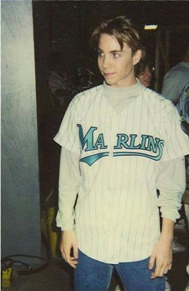 a young man in a baseball uniform posing for a photo