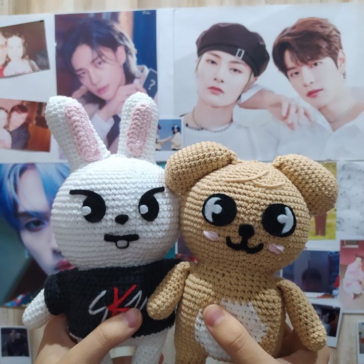 two crocheted stuffed animals are being held up by someone's hand with photos behind them