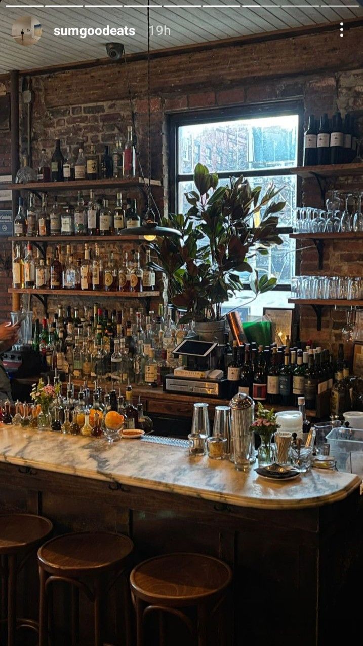 a bar with lots of bottles and glasses on it