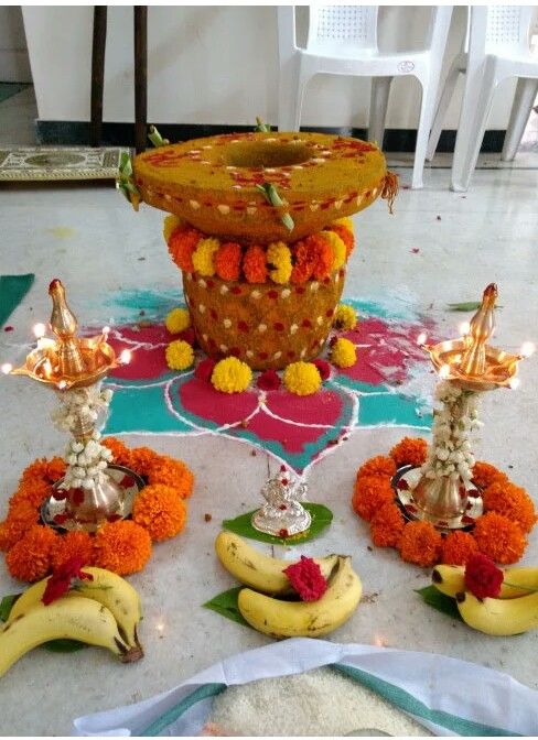 there are many decorations on the floor with bananas and flowers around them, along with candles