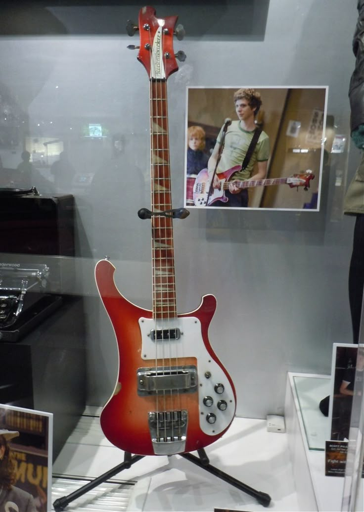 an electric guitar on display in a glass case