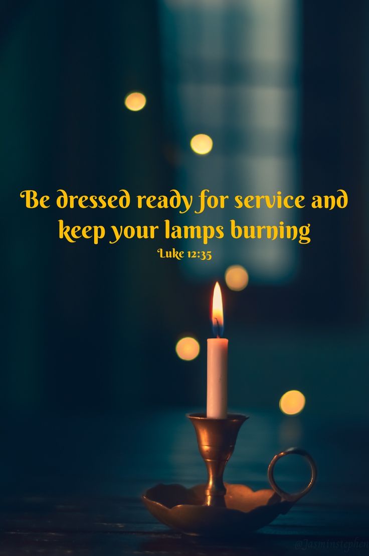 a lit candle with the words be dressed ready for service and keep your lamps burning