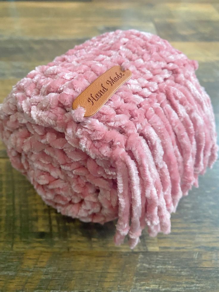 a pile of raw ground beef on a wooden surface with a label that says,