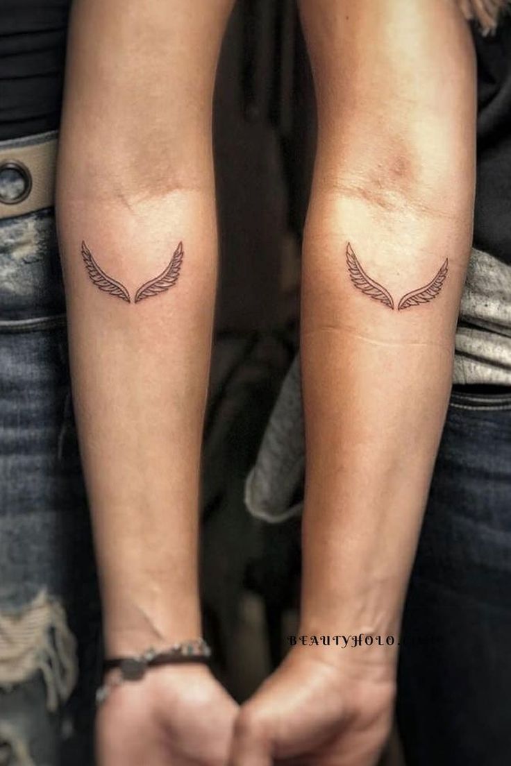 two people with matching tattoos on their arms