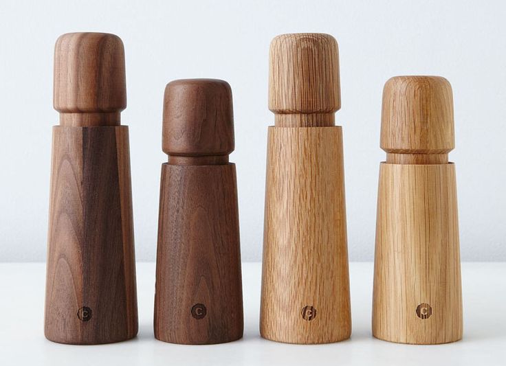 three wooden salt and pepper shakers lined up