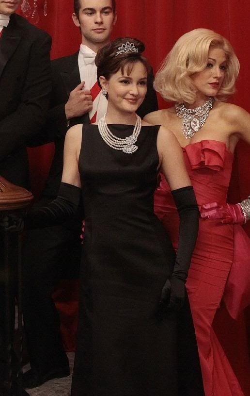 three people in formal wear standing next to each other with one woman wearing a tiara